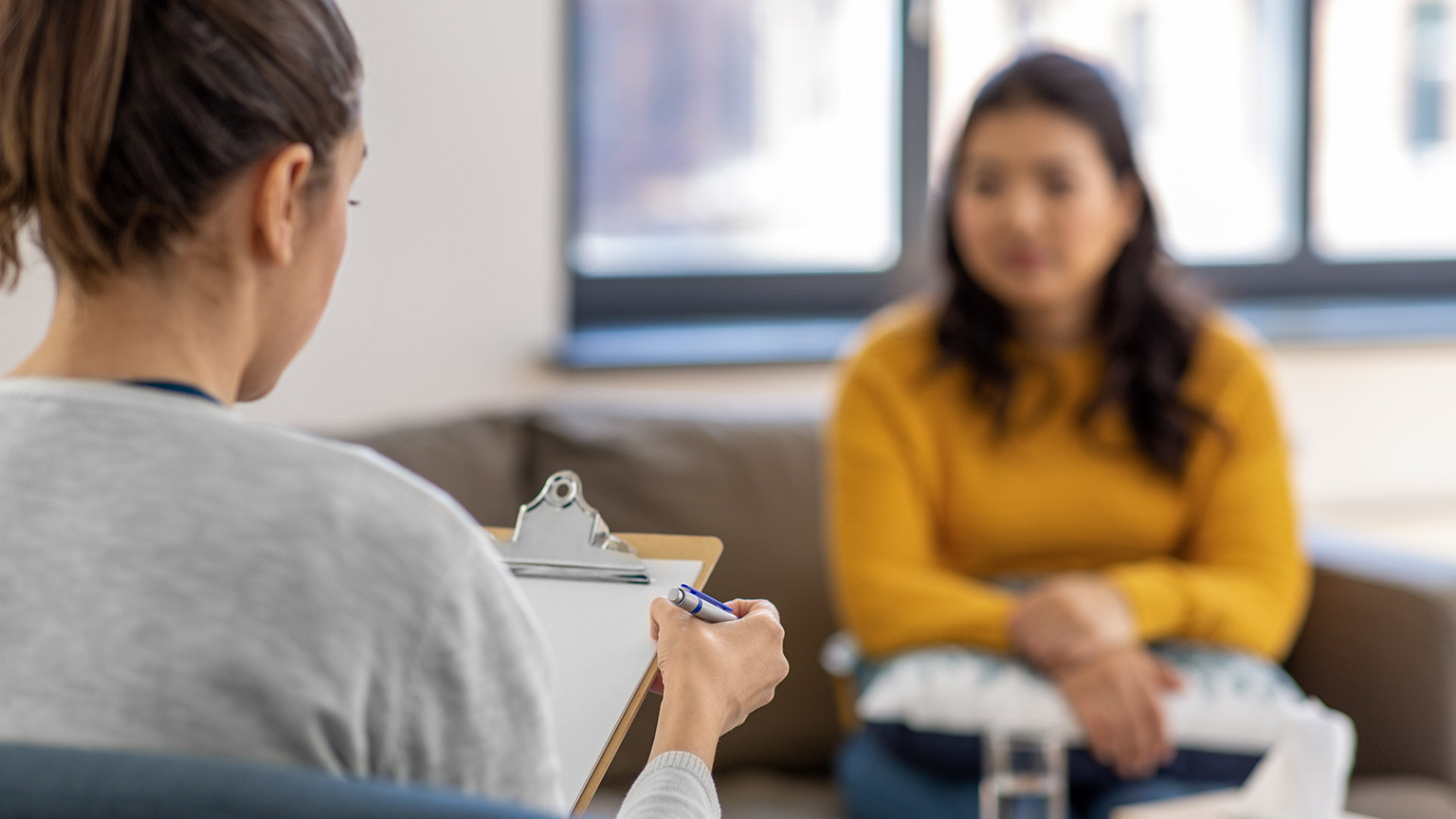 close up of woman psychologist and patient at psychotherapy session