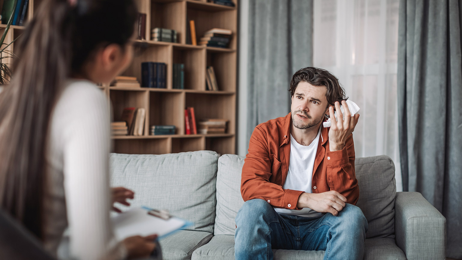 a depressed man having a counselling session with his therapist