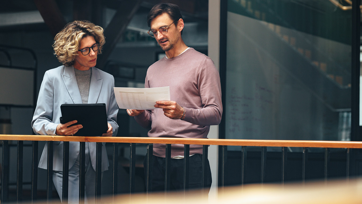 Two coworkers talking in an office