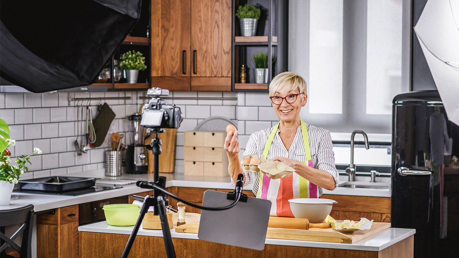 Elderly woman baking for her online streaming cooking channel.