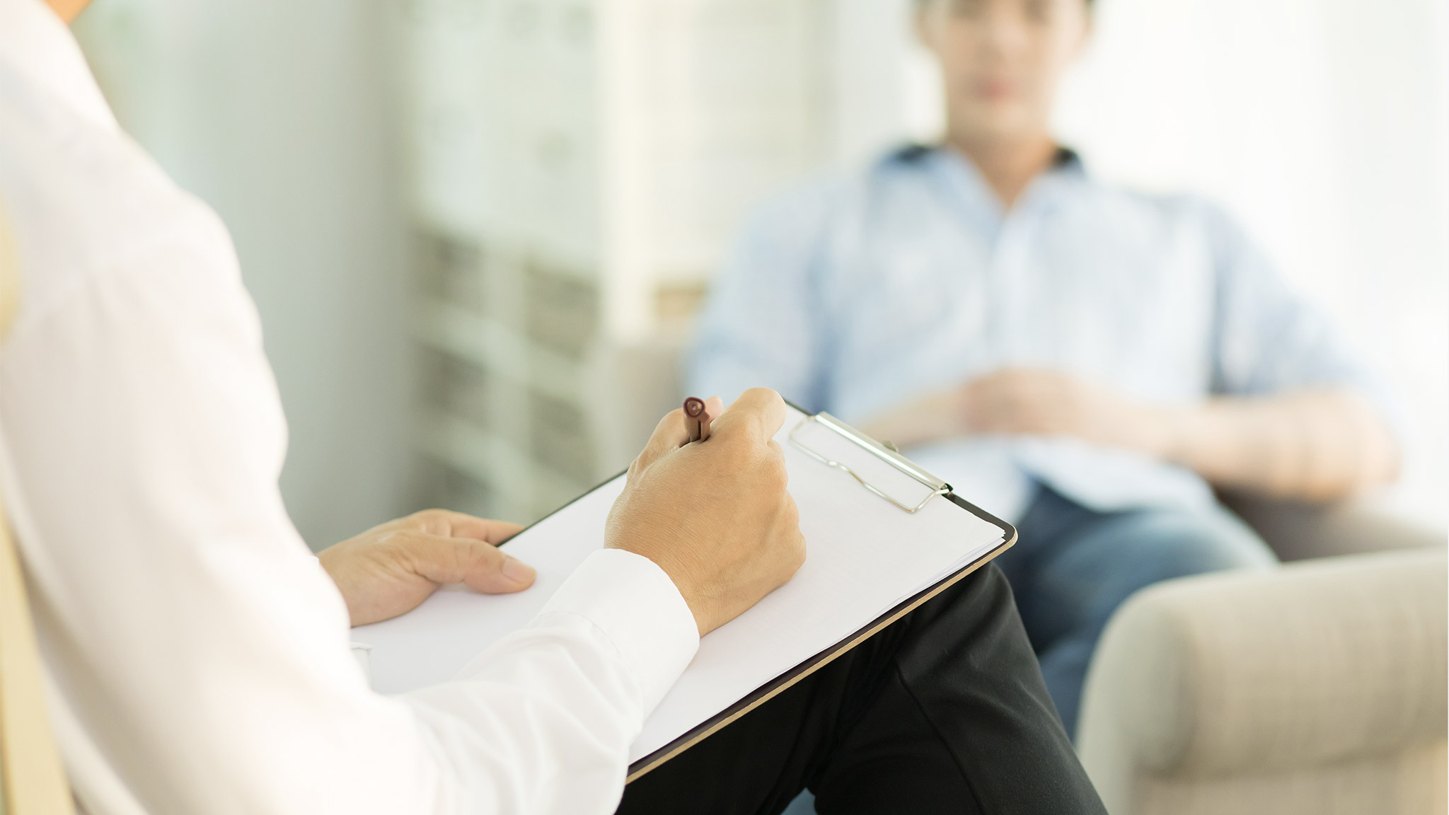 Counseling session between depressed Asian male patient and male psychologist