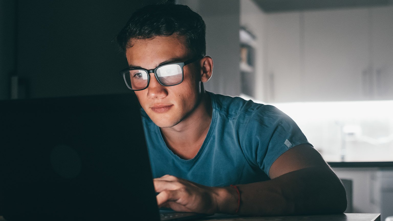 A student reading information on a laptop