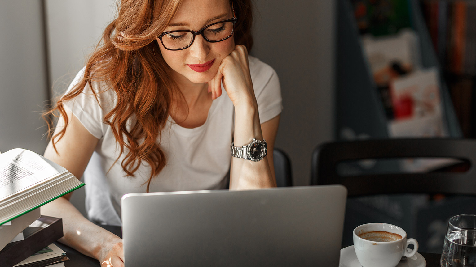 A person reading information on a laptop