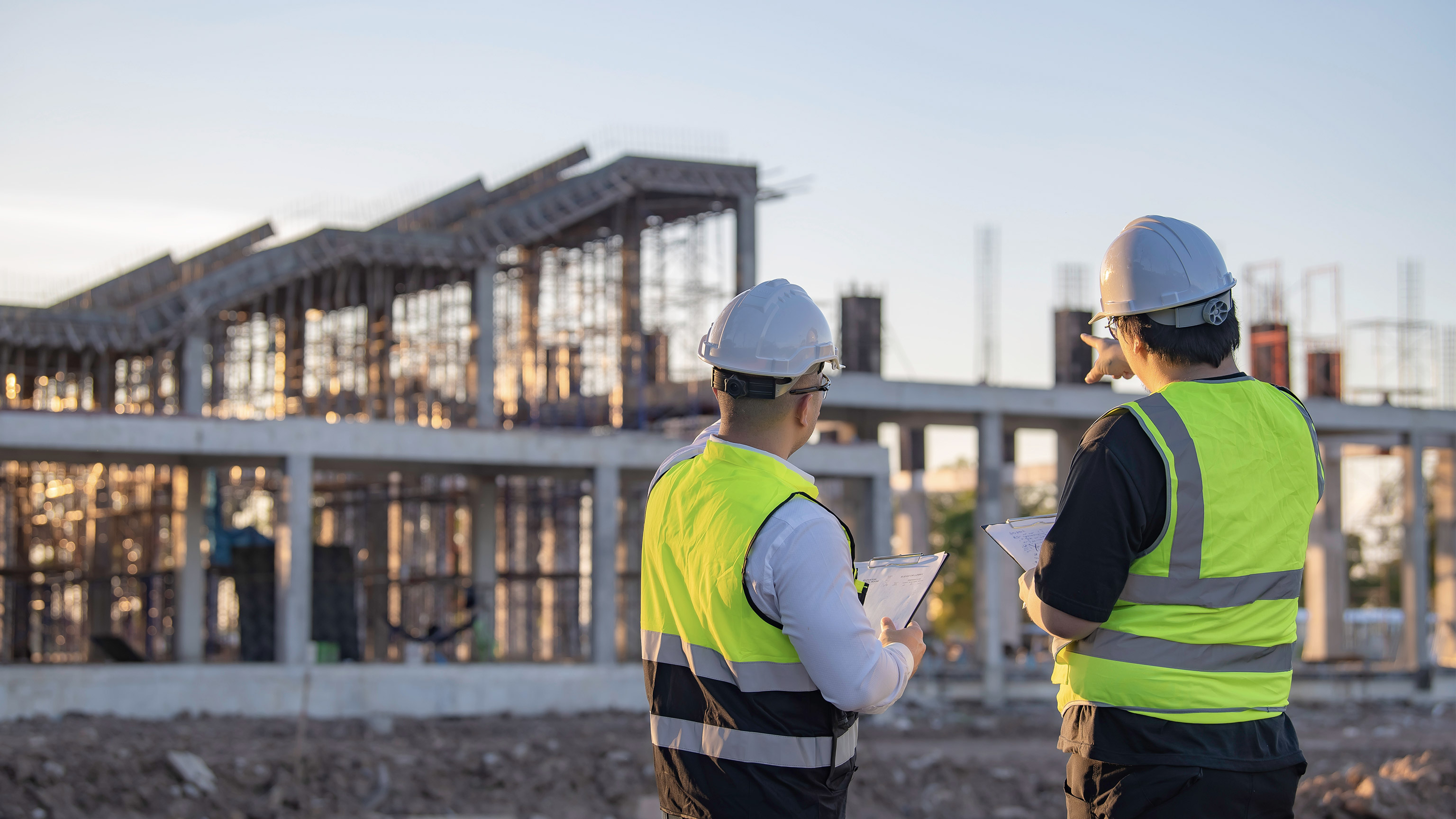 Two Asian engineer working at site