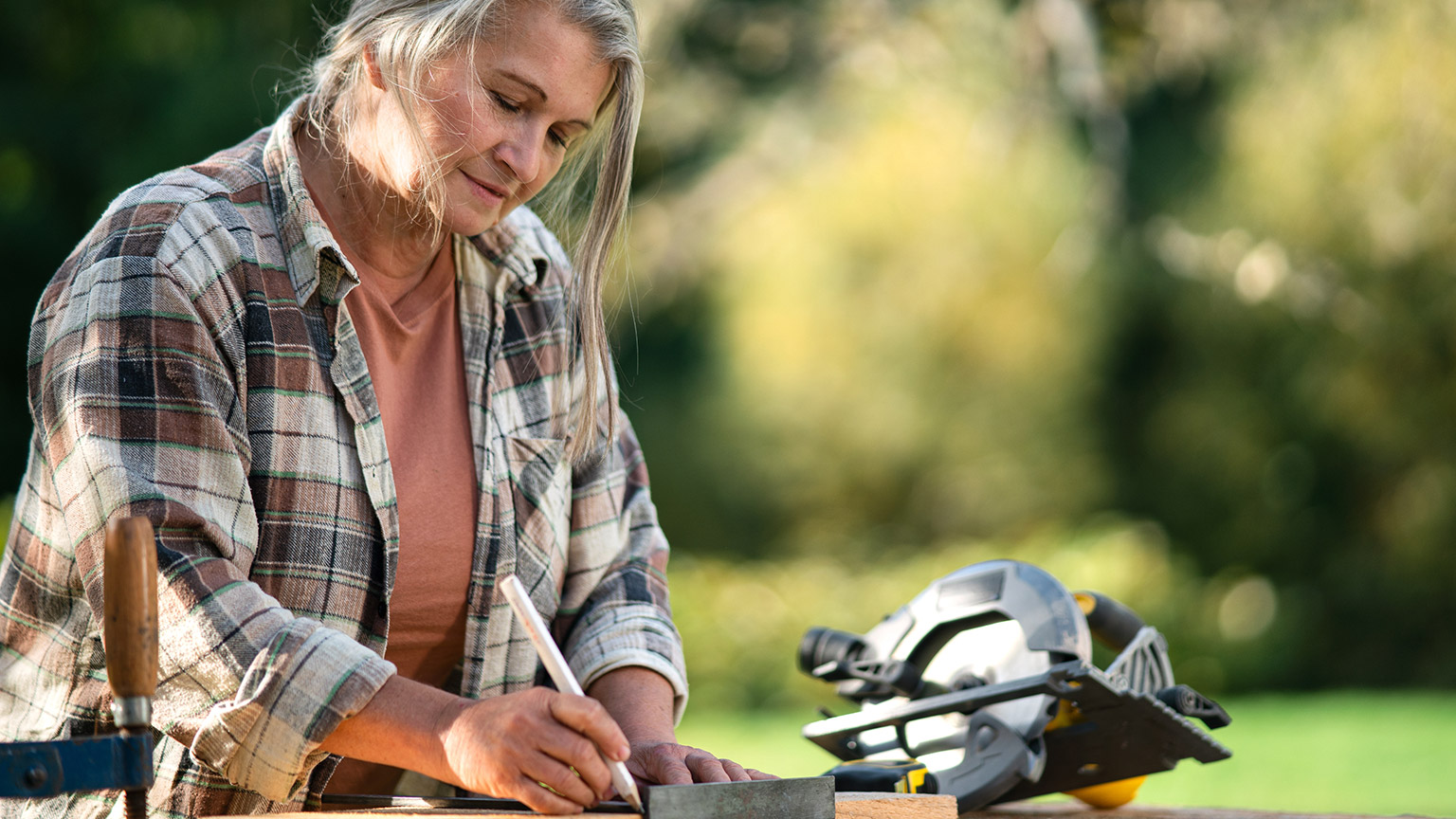 A person working with tools in a garden