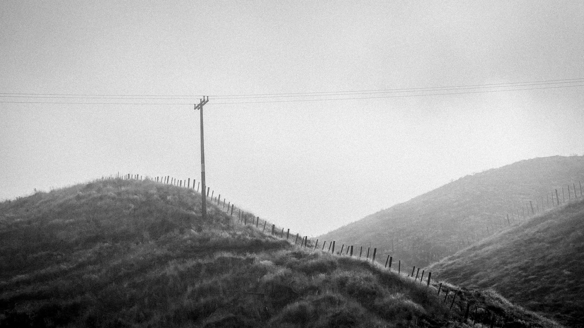 Black and white image of hills and telegraph pole