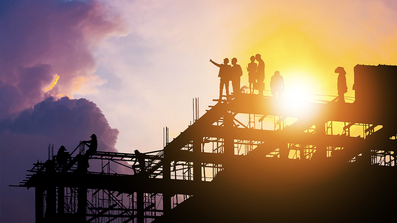 Silhouette of Engineer and worker on building site, construction site with clipping path at sunset in evening time