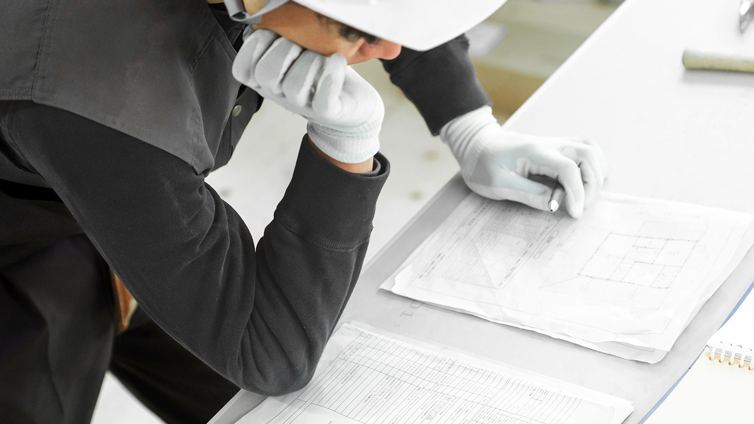 Man at construction site looking at plan