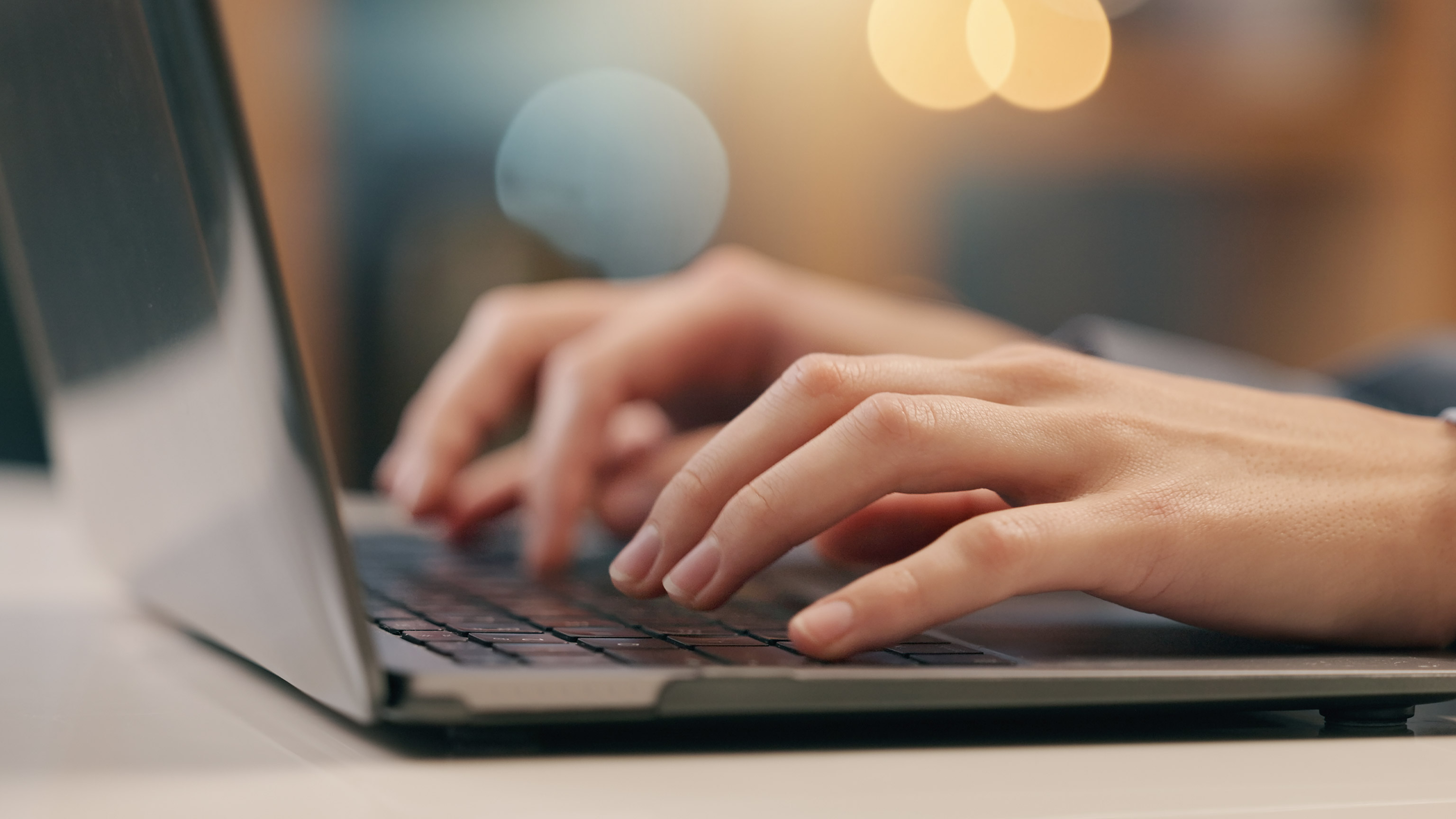 A close view of a person using a laptop