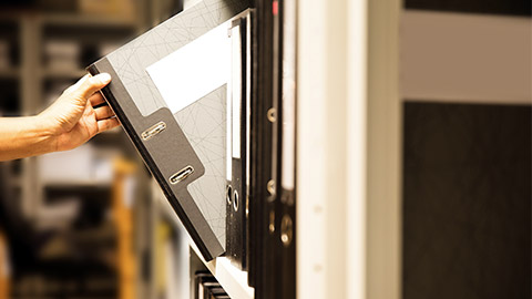 Hand of businessman office worker searching files and paperwork