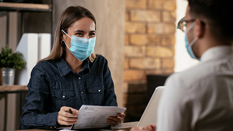 Two people doing a safety audit in an office