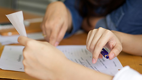 A person filling out paperwork