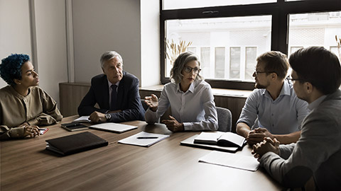 A group of professionals in suits discussing regulations