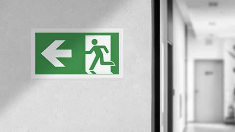 Fire exit sign in the corridor of the building