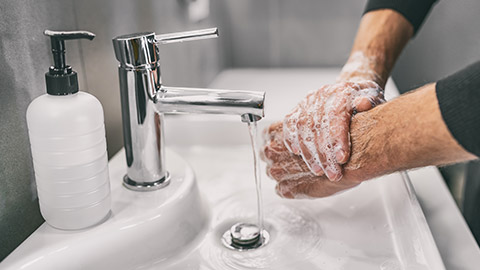 man washing hands rubbing with soap