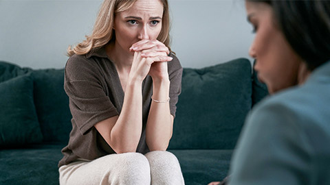 Caucasian female patient during the mixed race psychotherapy's visit