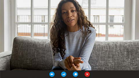 Computer screen view african woman sit on couch looking at webcam