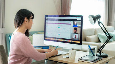 Asian business woman talking to her colleagues about plan in video conference