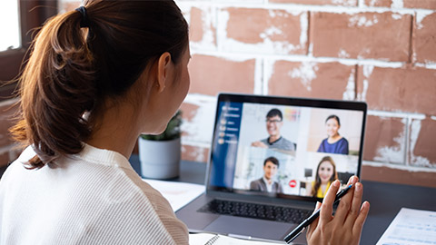 Young Asian businesswoman work at home and virtual video conference meeting with colleagues business people