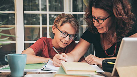 A mother demonstrating to her son how to solve a mathematics problem