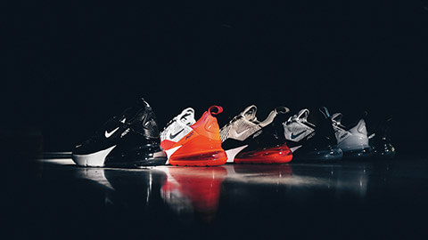 A line up of Nike shoes on a basketball court