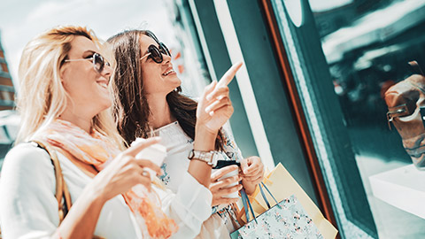 2 friends doing some window shopping in a city