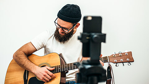 A guitar teacher hosting a guitar lesson on Zoom