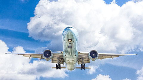 An aircraft carrying freight, taking off from an airport in the afternoon