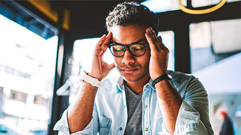 An employee taking a moment to themselves, to deal with the stress brought on by their customer-facing role