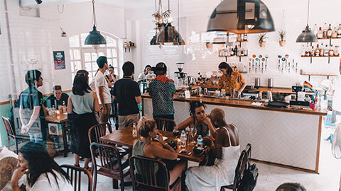 A view of customers eating and lining up to order at a cafe