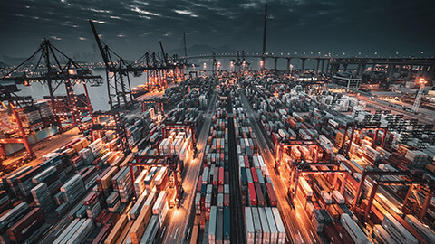 A busy shipping yard at dusk