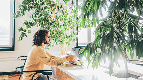 A designer sitting in an eco-friendly working space