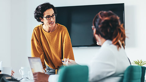 A manager discussing a project with 2 colleagues