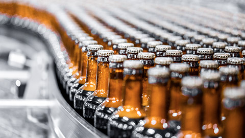 A shallow DOF view of a production line of glass bottles