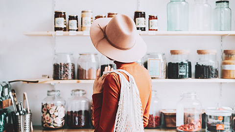 A shopper in a whole food store contemplating a purchase