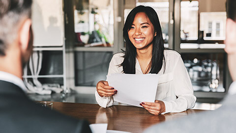 A young professional smiling confidently in an interview