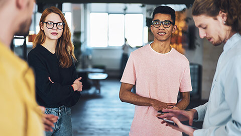 2 new starters with nervous looks receiving infomation from coworkers