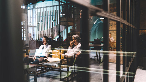 Finance brokers discussing a business venutre in a common area of their office