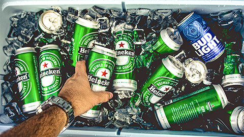 Many cans of Heineken beer on ice, in a large eski