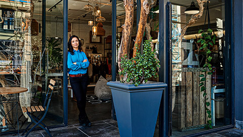 A shop owner standing in the entrance of their shop