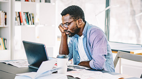 A person working on their laptop looking at social media responses