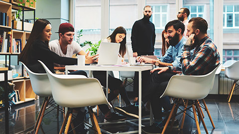 A group of young marketing professionals discussing a project at a table