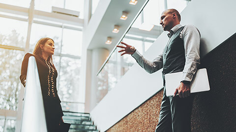 2 business colleagues having a serious discussion in a modern office space