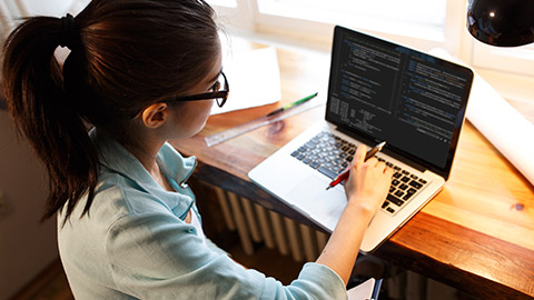 Young female programmer working at home