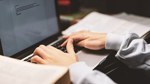 A close view of a gamer typing up a document