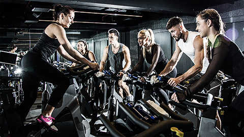 A person leading a spinning session