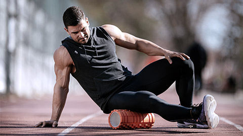 Man stretching using foam roller