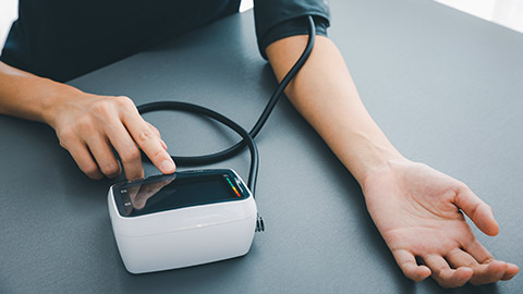 A person measuring blood pressure and heart rate