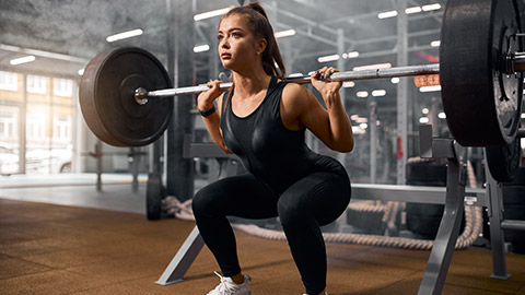 A person doing a squat in a gym