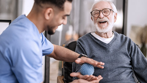 Senior patient having massage with spiky ball